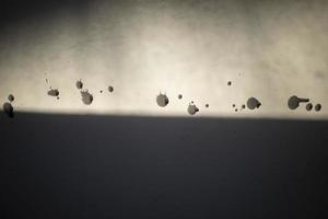 Dirt on wall. Black blobs on white wall. photo