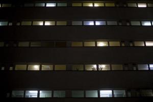 Windows in building at night. Unique architecture. photo