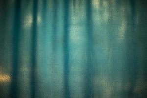 Blue fabric on window. Curtain in light. photo