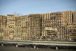 Lots of pallets. Warehouse of wooden pallets. Boarding. photo