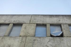 Windows closed with steel. Unfinished building. Abandoned house. Concrete structure. photo