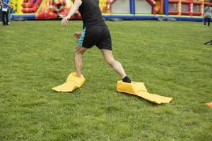 Child plays on green grass. Active lifestyle in summer. Children in park. photo