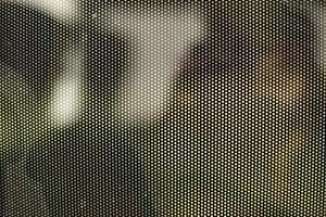 Mesh texture on glass. Shooting window. Small cage. photo