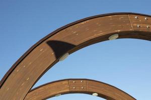 Wooden arch. Construction against sky. photo