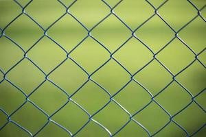 Mesh fence on vernacular background. Fence details. photo