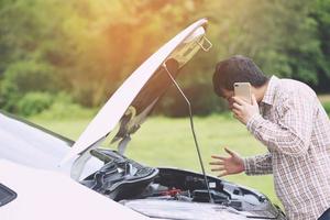 Angry man Stand front a broken car calling for assistance photo