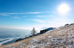 Landscape of frozen Lake Baikal in winter with background of blue sky from high view point. photo
