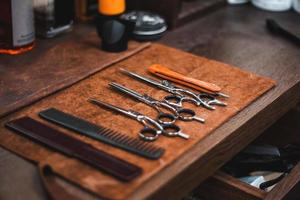 Barber shop tools on old wooden background.Barber vintage tools for beard grooming in retro barber shop photo