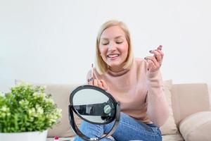 Woman Applying Black Mascara on Eyelashes with Makeup Brush. Beauty Make-up. Portrait Of Beautiful Young Woman Applying Black Mascara On Lashes, Holding Brush In Hand. photo