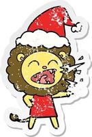 distressed sticker cartoon of a roaring lion girl wearing santa hat vector