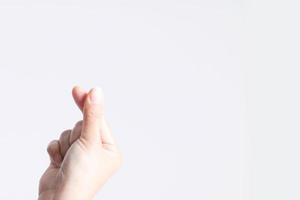 Close-up image of a symbol from a fingertip to be Love signs in Korean style called mini heart or little heart. photo