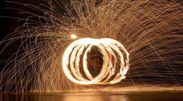 Fire dancers Swing fire dancing show fire show on the beach photo