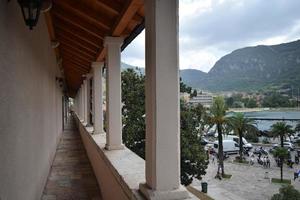 a long balcony with columns and arches and a view of the Bay of Kotor of the Adriatic Sea photo