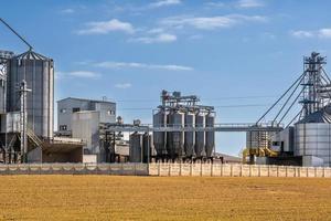 agro silos granary elevator on agro-processing manufacturing plant for processing drying cleaning and storage of agricultural products, flour, cereals and grain. photo