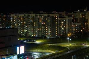 Night panorama of Light in the windows of a multistory building. life in a big city photo