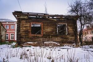 Old broken house in winter photo