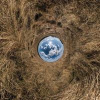 blue sphere little planet inside green grass round frame background. photo