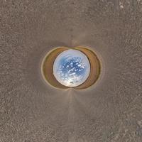 blue sphere little planet inside gravel road background. photo