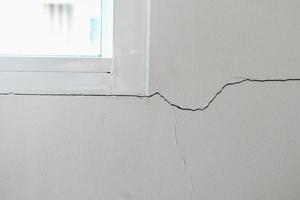 New house wall crack near window frame photo