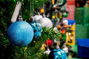 Decorated Christmas tree with colorful bauble on sparkling bokeh light blurred background photo