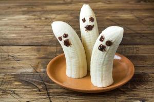 Painted funny faces on bananas for Halloween photo