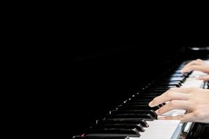 Close up musician hand playing piano photo