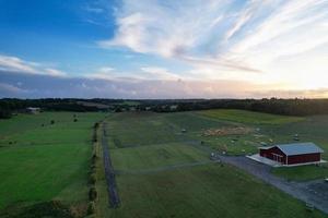 High angle view of cows grazing on field against sky. Gorgeous high angle aerial view of Animal Farm at British Agricultural Field Near London England Great Britain of UK photo