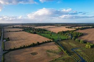 High angle view of cows grazing on field against sky. Gorgeous high angle aerial view of Animal Farm at British Agricultural Field Near London England Great Britain of UK photo