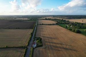 High angle view of cows grazing on field against sky. Gorgeous high angle aerial view of Animal Farm at British Agricultural Field Near London England Great Britain of UK photo