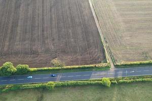 High angle view of cows grazing on field against sky. Gorgeous high angle aerial view of Animal Farm at British Agricultural Field Near London England Great Britain of UK photo