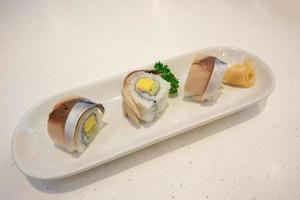 Saba sushi roll on white plate photo