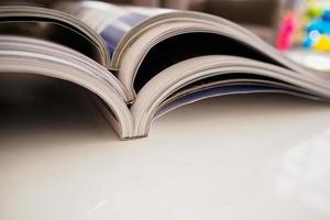 pile of magazines stack on white table in living room photo