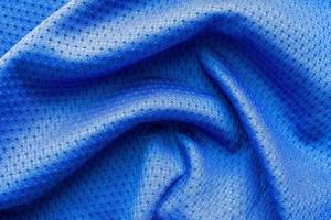 Blue color fabric sport clothing football jersey with air mesh texture background photo