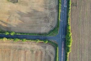 High angle view of cows grazing on field against sky. Gorgeous high angle aerial view of Animal Farm at British Agricultural Field Near London England Great Britain of UK photo