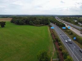 High Angle View of British Motorways with Traffic. The Aerial footage of British Roads and Motorways at between M1 Junction 7 and 9 at Sunset. The Footage captured on 09-07-2022 with drone's camera photo
