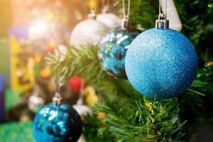 Decorated Christmas tree with colorful bauble on sparkling bokeh light blurred background photo