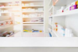 wood counter with blur shelves of drug in the pharmacy photo