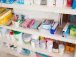 Close up of medicine bottles on shelves of drugs in the pharmacy photo