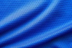 Blue color fabric sport clothing football jersey with air mesh texture background photo
