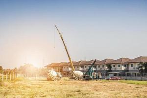 House building at construction site with crane truck photo