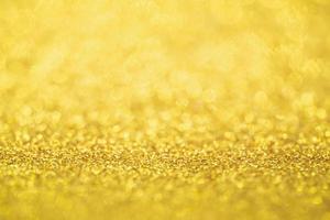 Desenfoque de fondo de textura navideña festiva con brillo dorado abstracto con luz bokeh foto