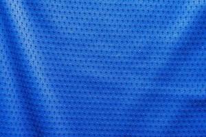 Blue color fabric sport clothing football jersey with air mesh texture background photo