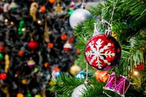 Decorated Christmas tree with colorful bauble on sparkling bokeh light blurred background photo