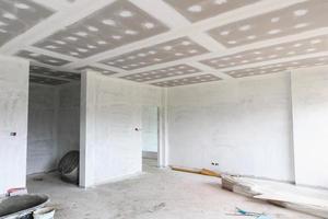 Empty room interior with gypsum board ceiling at construction site photo