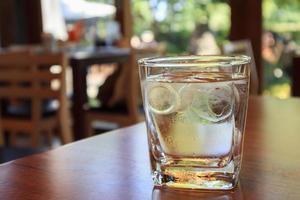 glass of water on wood table in restaurant photo