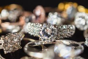 Jewelry diamond rings set on black background close up photo