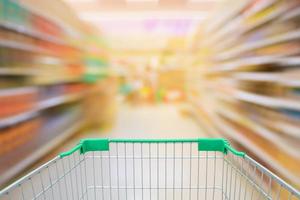 Supermarket motion blur aisle with shopping cart photo