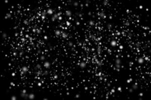 Abstract snowfall on black background photo