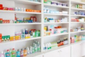 Pharmacy drugstore blur abstract backbround with medicine and healthcare product on shelves photo