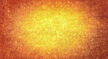 Yellow Orange colour golden grunge wall texture weathered background with space for text photo